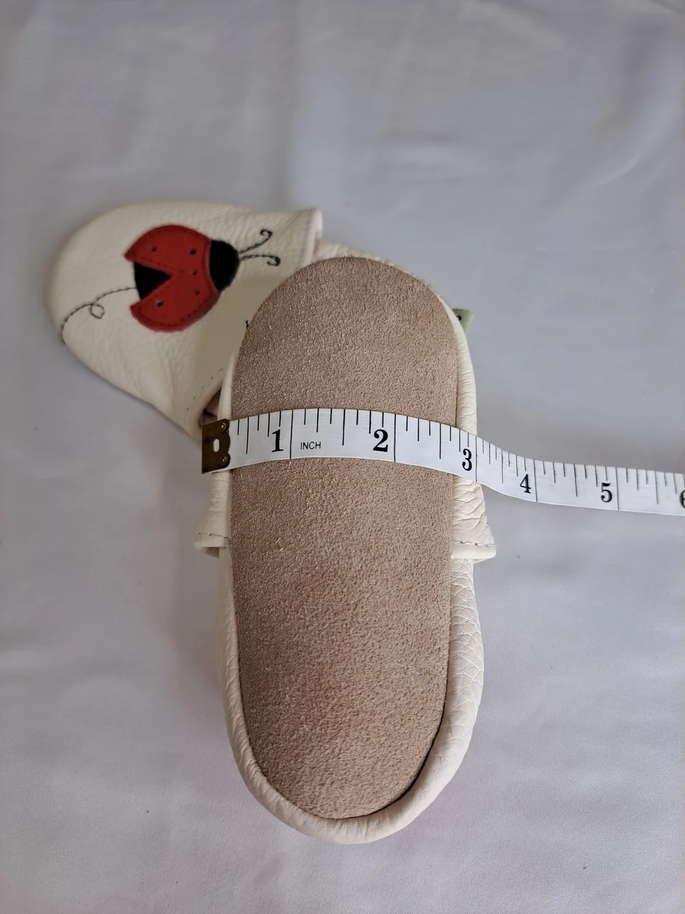 Baby White Leather Slip-On Shoes with Red Ladybug Detail
